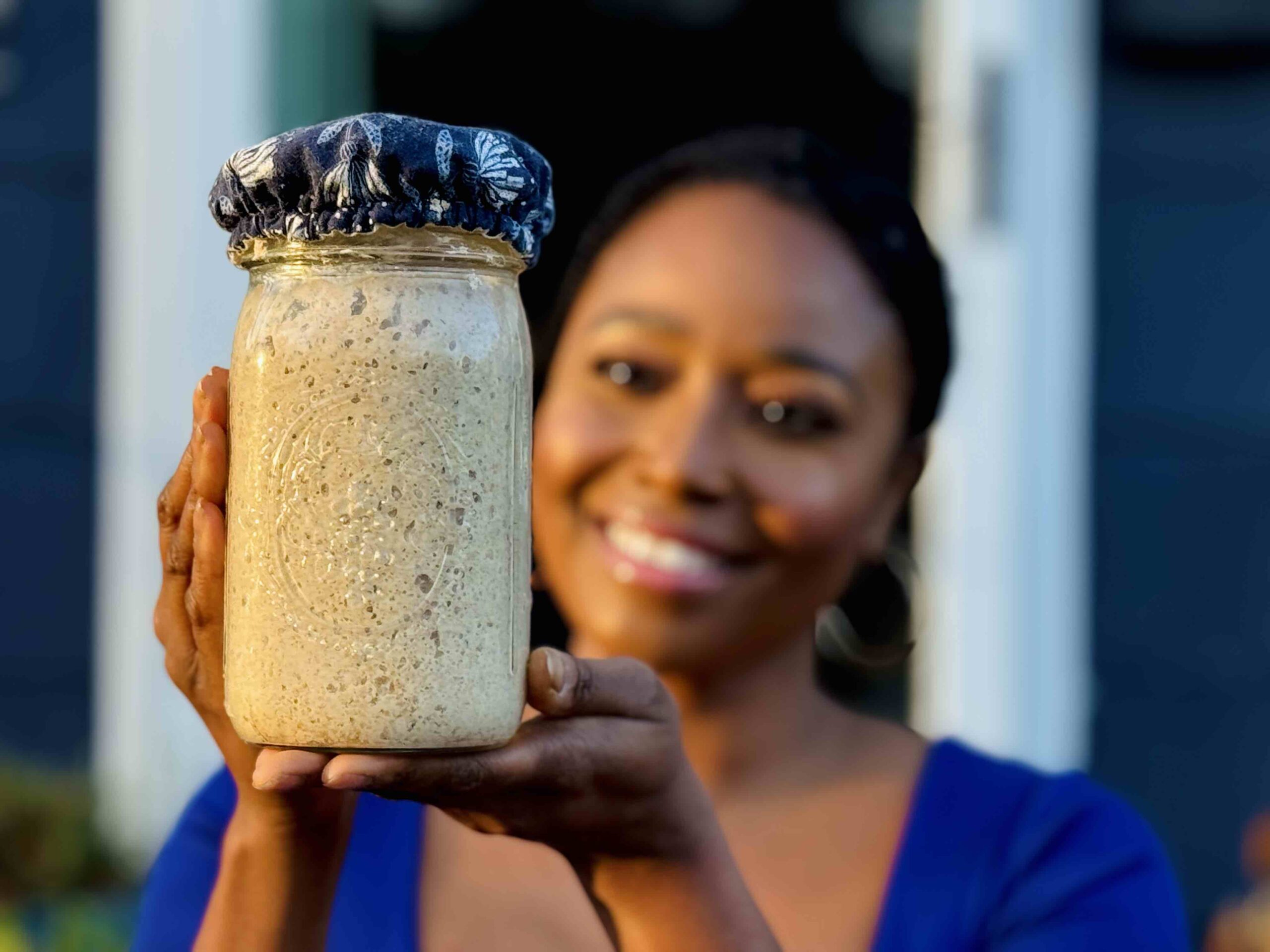 sisterfrennn - cierra holding jar of sourdough starter